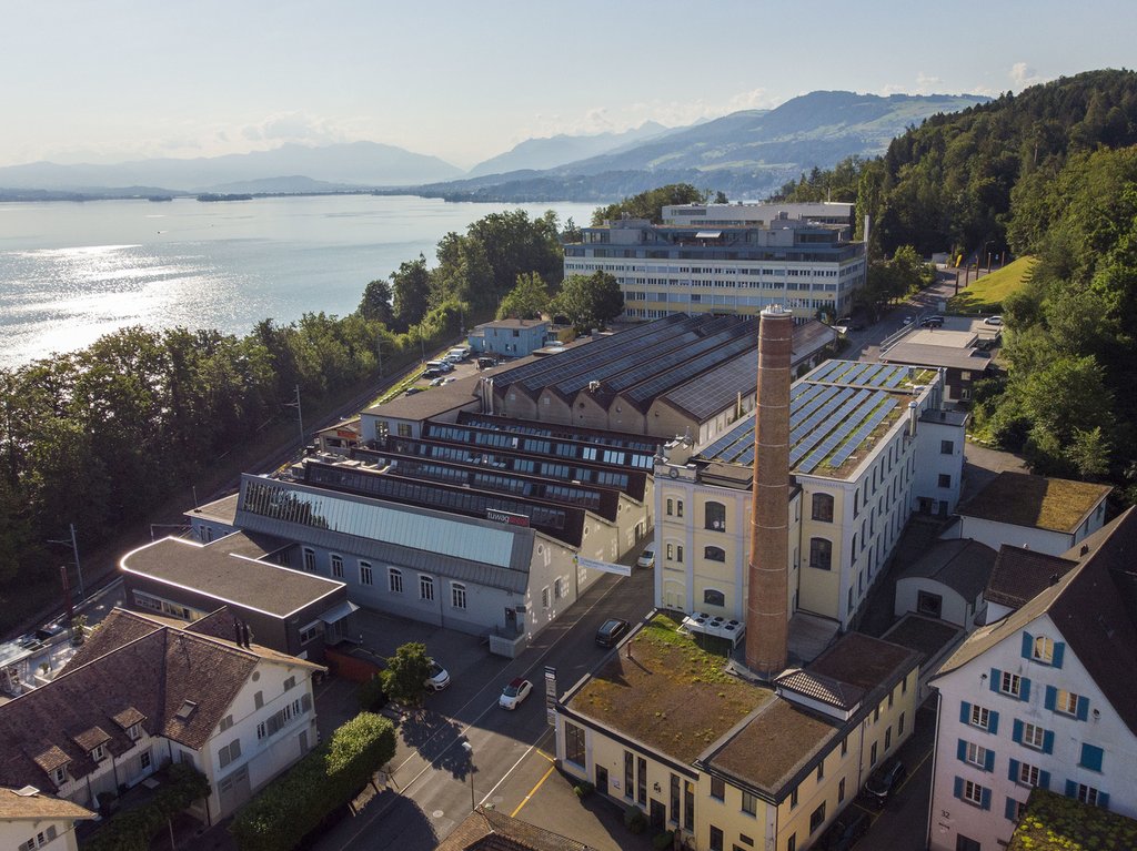 Die THG-Emissionen in der Schweiz sinken insbesondere dank energieeffizienten Gebäuden. Das historische Tuwag-Areal in Wädenswil hat Photovoltaik-Anlagen auf dem Dach. Geheizt wird nicht mehr mit Öl und Gas, sondern mit einer Holzschnitzelheizung. (Keystone-SDA)